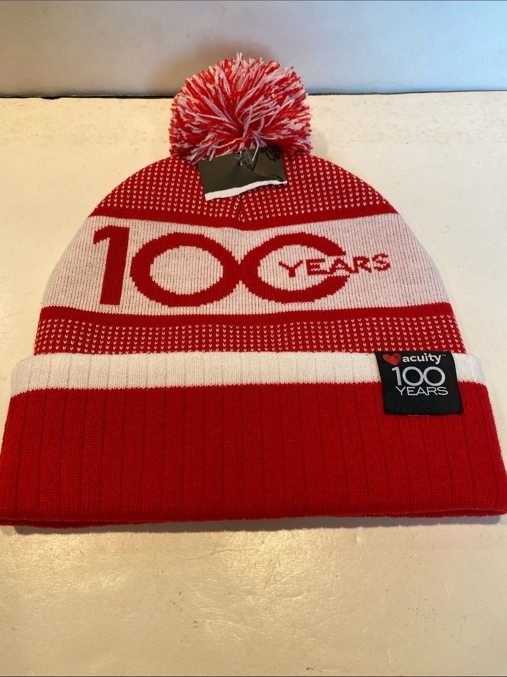 NWOT Acuity 100 Years Pom-Pom Hat